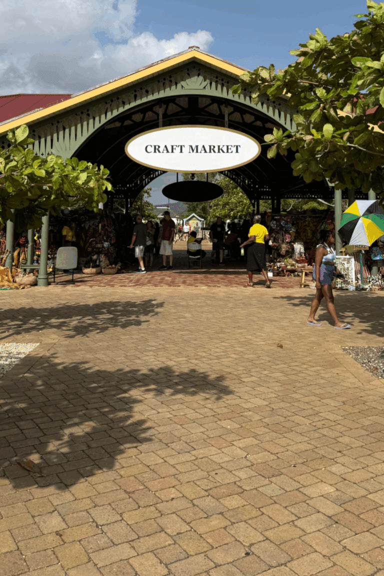 Colorful craft stalls inside the Falmouth Cruise Port market, featuring handmade Jamaican souvenirs and local artwork