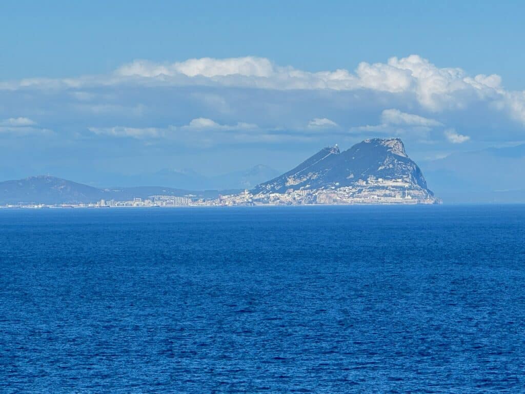 Cruise ship sailing through the Strait of Gibraltar, with the Rock of Gibraltar rising along the coastline during a Strait of Gibraltar cruise.