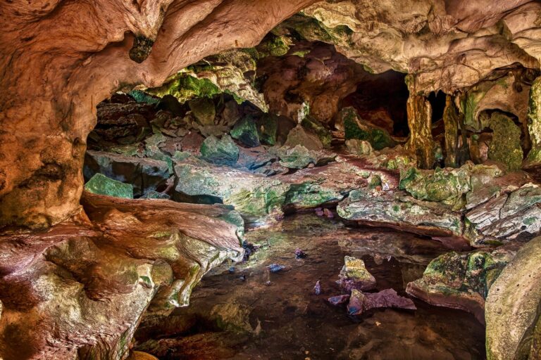 Interior view of Green Grotto Caves in Jamaica, showing natural limestone formations and the dim, atmospheric lighting inside the cavern