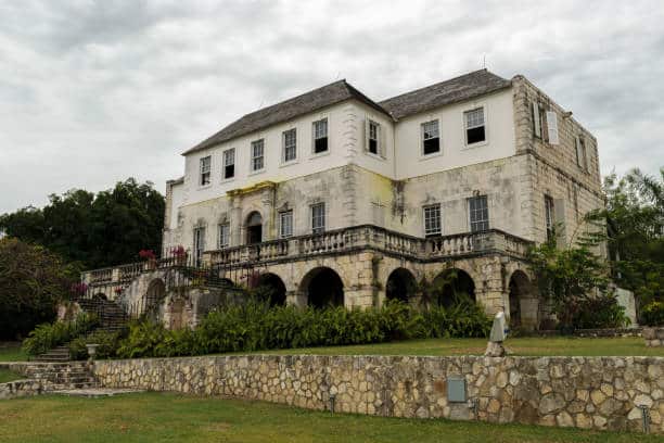 Exterior view of Rose Hall Great House in Montego Bay, Jamaica, with Georgian architecture and ocean views