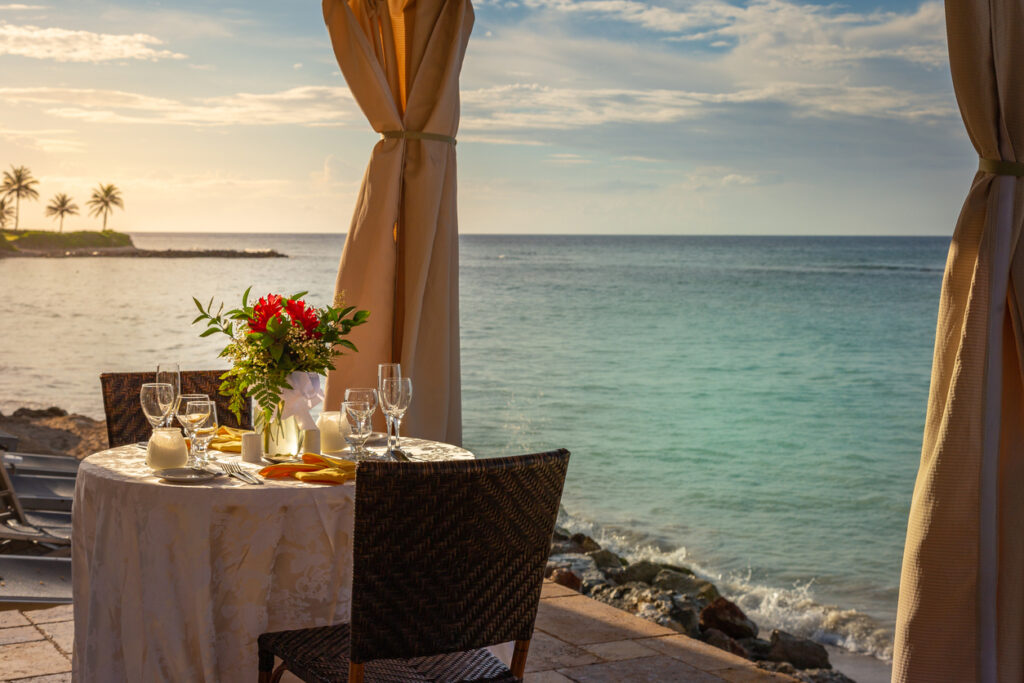 Romantic private table for two set under a gazebo, showcasing an intimate excursion option during an anniversary celebration cruise.