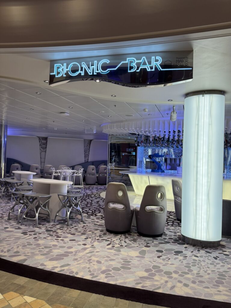 Bionic Bar on Oasis of the Seas with its futuristic robotic bartenders, glowing signage, and modern lounge seating.