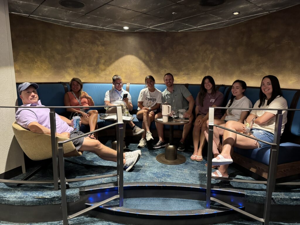 Group gathered inside Music Hall during a lively birthday cruise celebration, enjoying the atmosphere of one of Royal Caribbean’s signature bars.