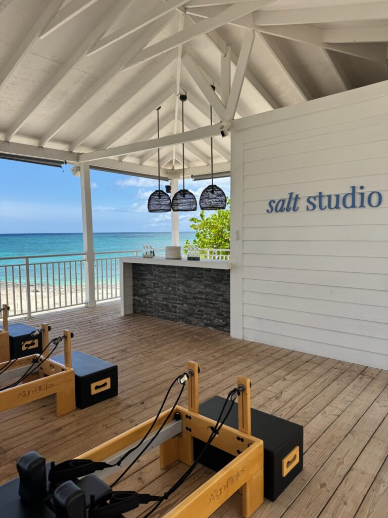 Beachfront Pilates studio set up for a private wellness session, showcasing a unique excursion option during a birthday cruise celebration.