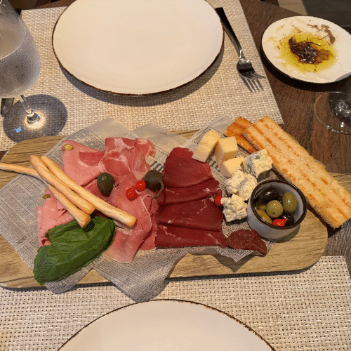 Table at Giovanni’s Italian specialty restaurant on a Royal Caribbean ship, featuring a spread of pasta, appetizers, and fresh dishes enjoyed during a perfect sea day lunch.