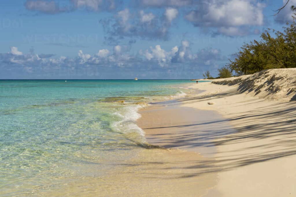 Calm turquoise water and soft white sand at Governor’s Beach on Grand Turk, surrounded by sea grape trees
