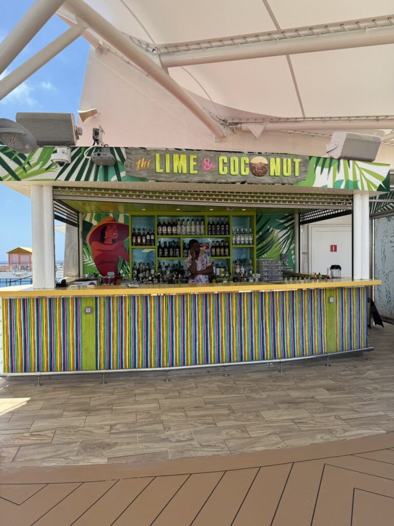 The Lime & Coconut bar on the upper terrace of Oasis of the Seas, showing its colorful tropical design and quiet, tucked‑away setting.