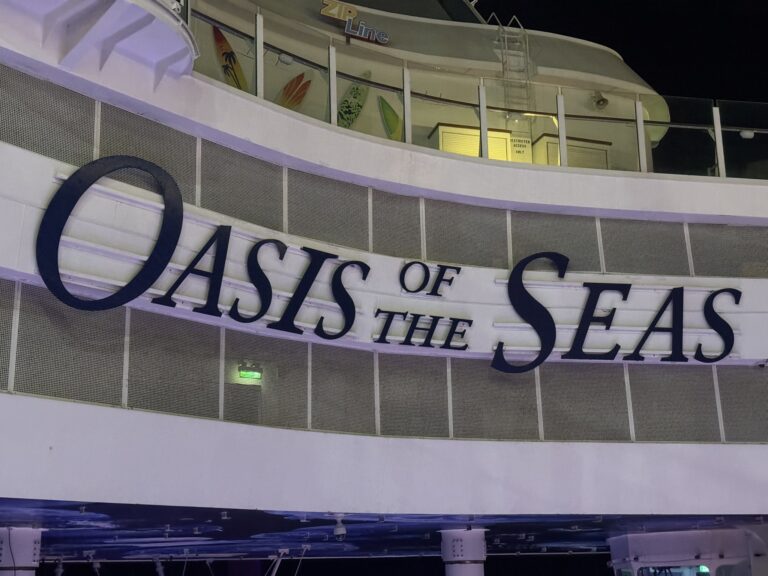 Close-up view of the “Oasis of the Seas” signage on the Boardwalk neighborhood inside the ship, highlighting the ship’s name during an Oasis of the Seas cruise.
