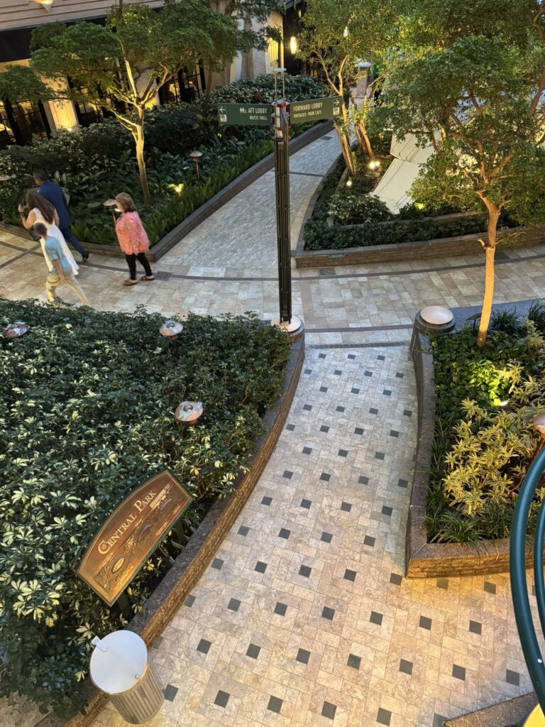 Central Park on Oasis of the Seas with lush greenery, walking paths, and open seating areas, featured in the solo‑travel section of the Oasis of the Seas guide.