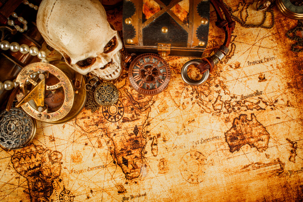 Vintage nautical still life with rope, compass, and aged map representing Nassau’s pirate history