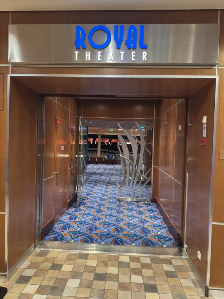 Entrance to the Royal Theatre on Oasis of the Seas, showing the illuminated marquee and guests approaching the doors.