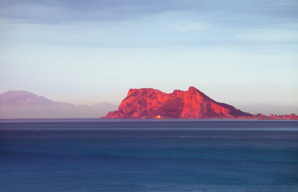 Cruise ship sailing through the Strait of Gibraltar, with the Rock of Gibraltar rising along the coastline during a Strait of Gibraltar cruise.