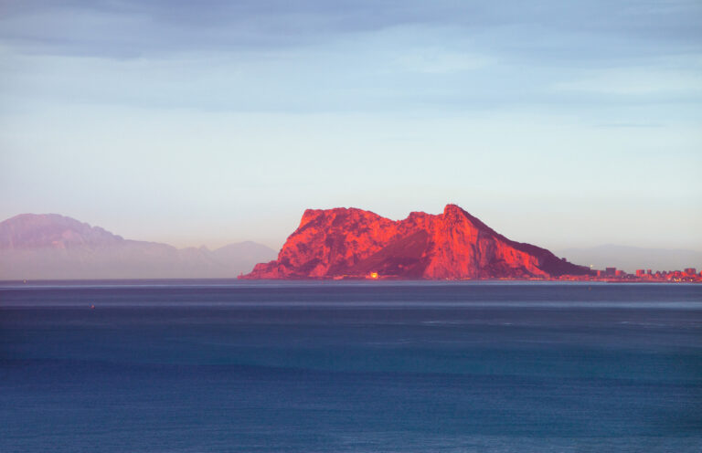 Cruise ship sailing through the Strait of Gibraltar, with the Rock of Gibraltar rising along the coastline during a Strait of Gibraltar cruise.