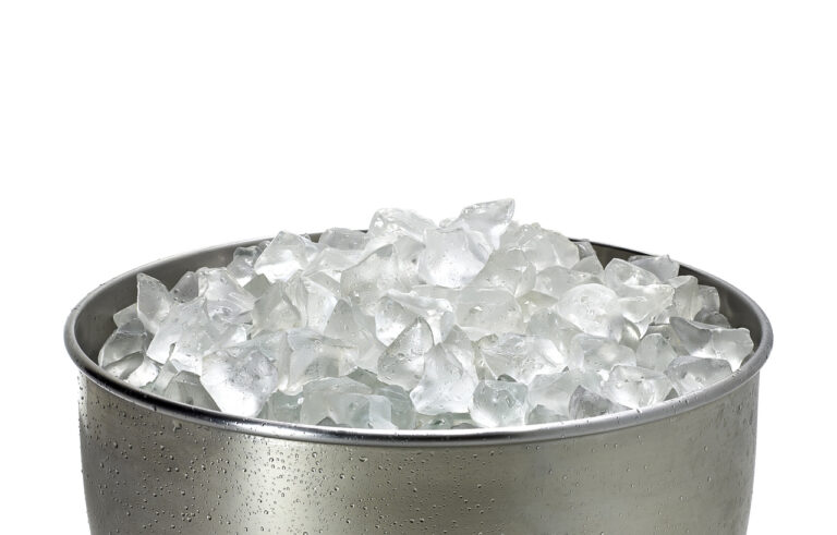 Close‑up of a cruise stateroom ice bucket filled with fresh ice, illustrating one of the helpful amenities included in what your room steward can bring you during your cruise.