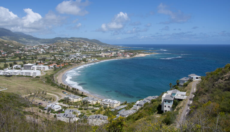View of the calm Caribbean Sea from Timothy Hill Overlook in St. Kitts, with blue water and coastal scenery.