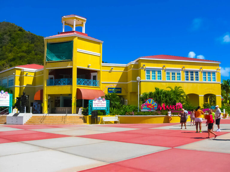 Tourists walking along Dr. Wathey Pier in Philipsburg on the Dutch side of St. Maarten, heading into town for shopping and beaches.