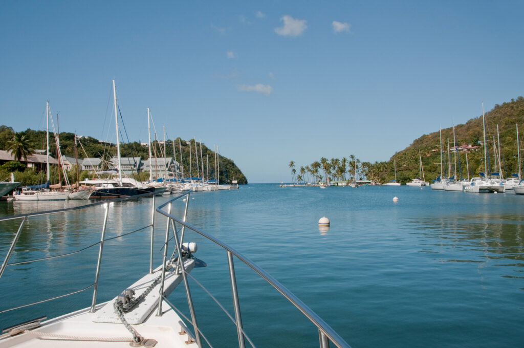 Calm turquoise water and lush green hills surrounding Marigot Bay on the western coast of St. Lucia.