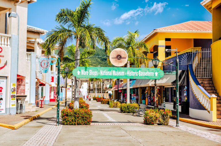 Colorful street and shopping area in Basseterre, St. Kitts, showing local shops and everyday life near the cruise port.