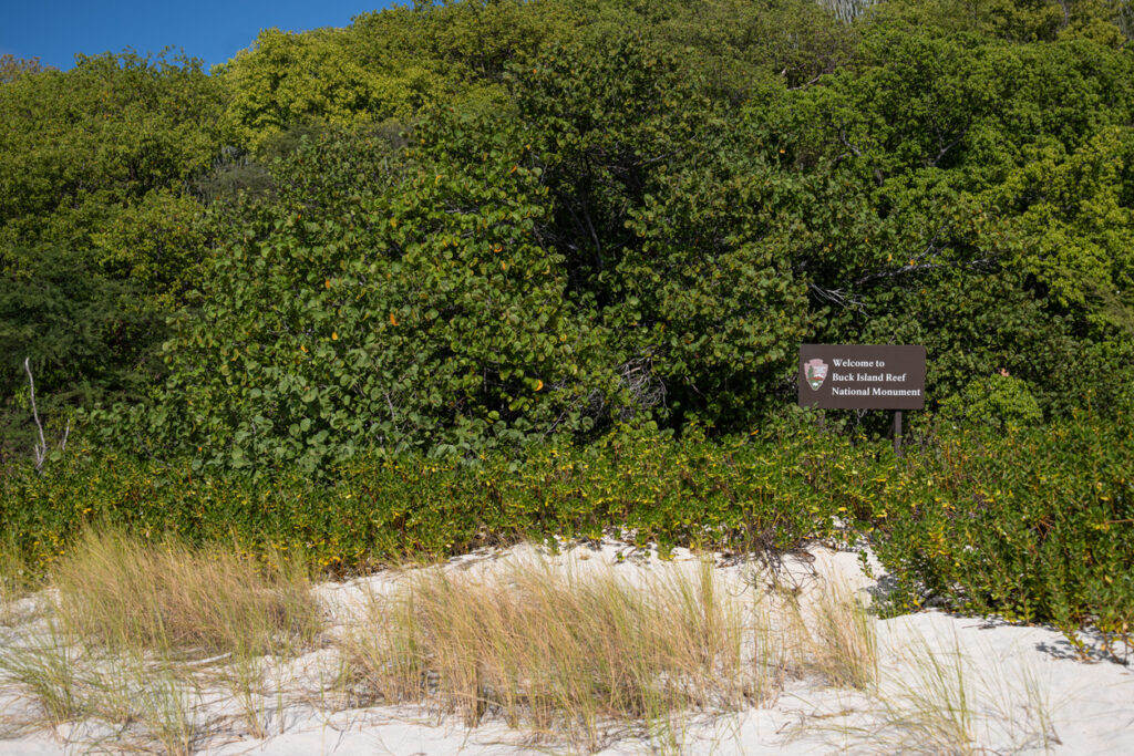 Sign at Buck Island Reef National Monument welcoming visitors to the protected marine sanctuary.