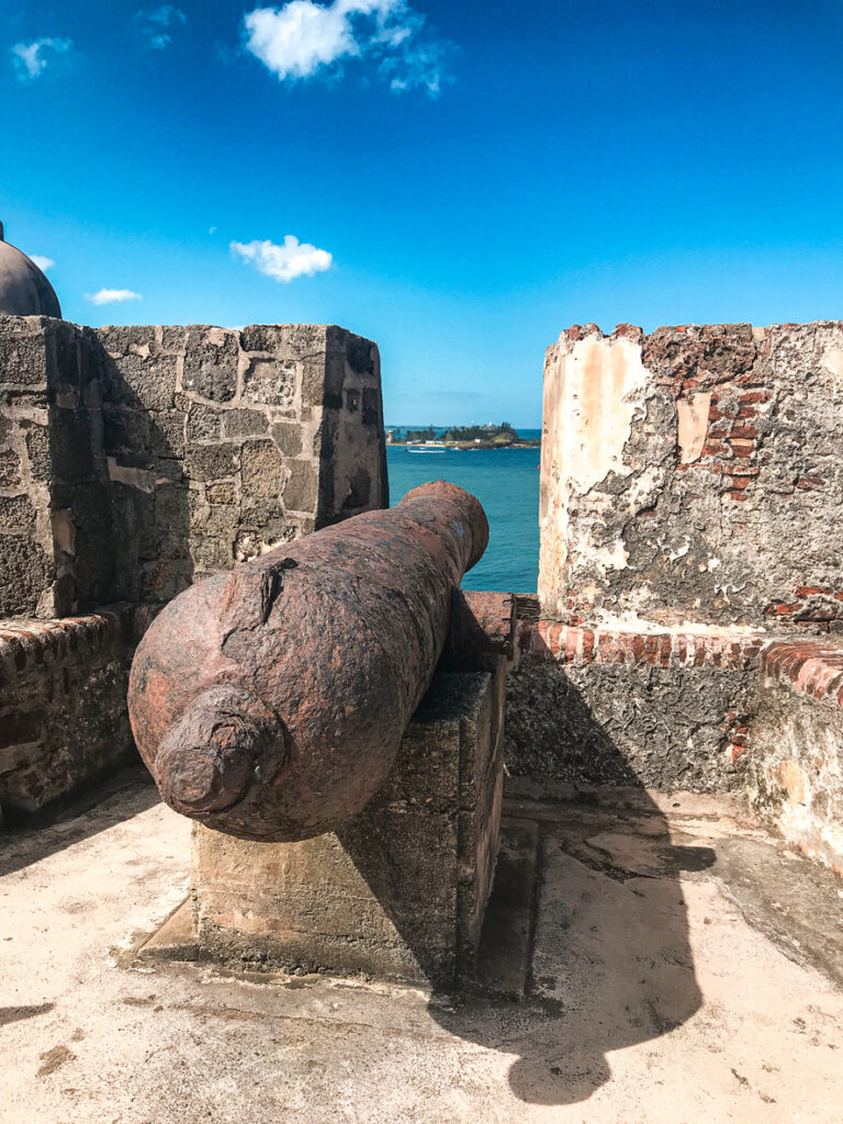 Historic cannon on the walls of Castillo San Cristóbal in San Juan, Puerto Rico, overlooking the sea from the centuries‑old fortress.