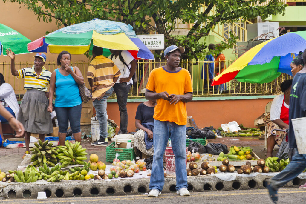 Colorful stalls at Castries Market in St. Lucia displaying local crafts, spices, and fresh produce.