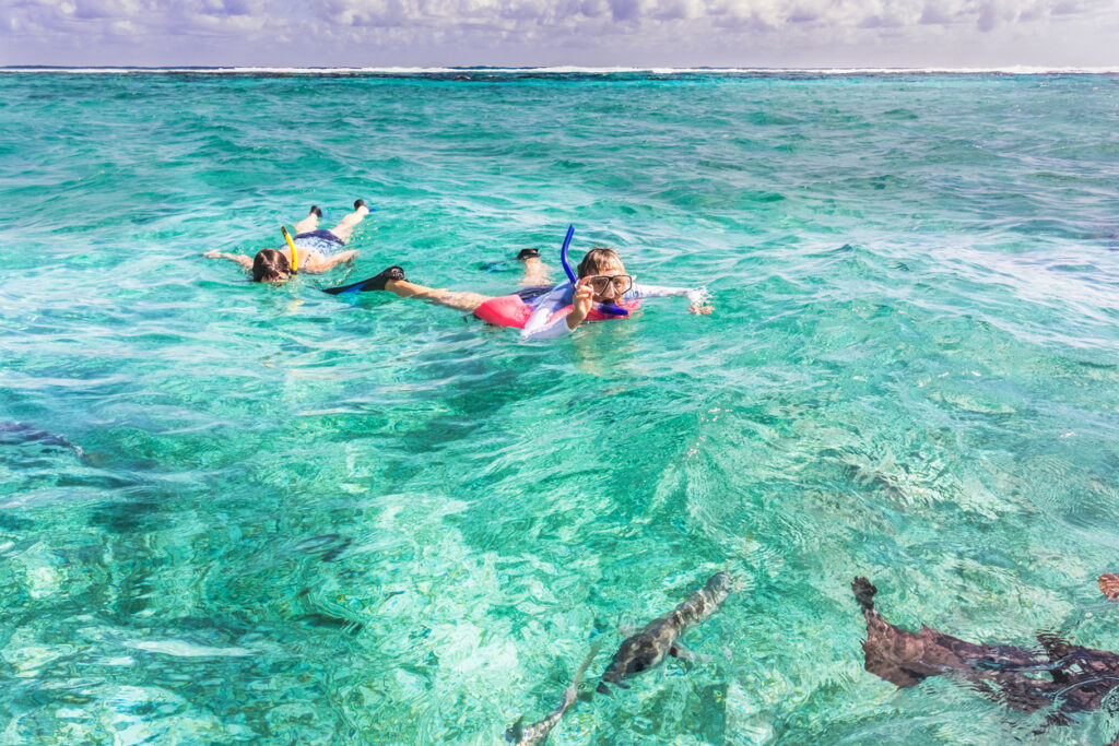 Snorkelers exploring the reef near Caye Caulker in Belize, a popular island close to the Belize Barrier Reef
