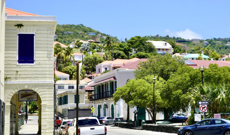 Colorful waterfront view of Charlotte Amalie in St. Thomas with historic buildings and harbor scenery