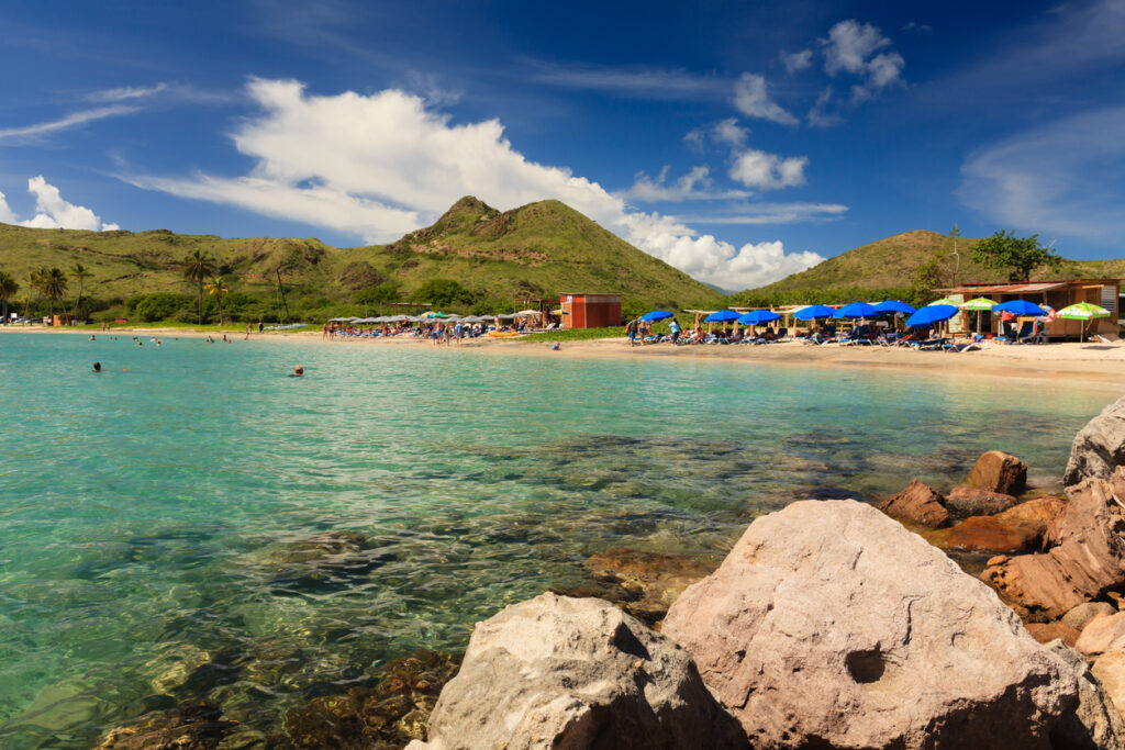 Cockleshell Beach in St. Kitts with calm turquoise water, soft sand, and views of Nevis across the channel.