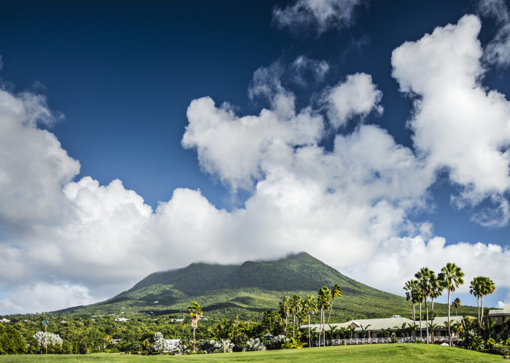 View of Nevis Peak rising above lush tropical landscape on Nevis, showcasing the island’s volcanic mountain.