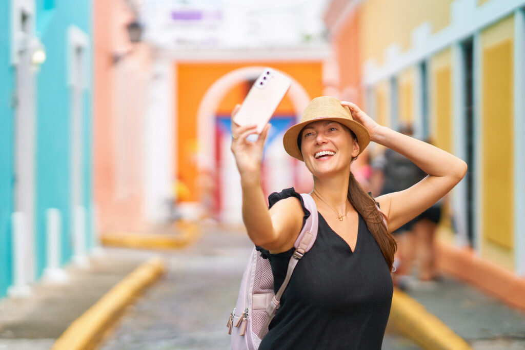 Woman exploring the colorful streets of Old San Juan, a popular spot for taking vibrant travel photos.