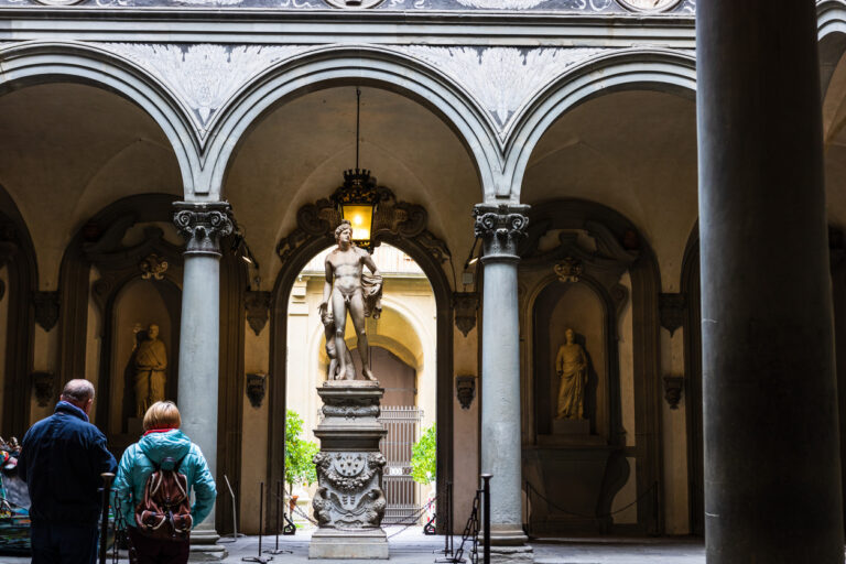 Tourists looking at David by Michelangelo in Galleria dell'Accademia in Florence. Italy.