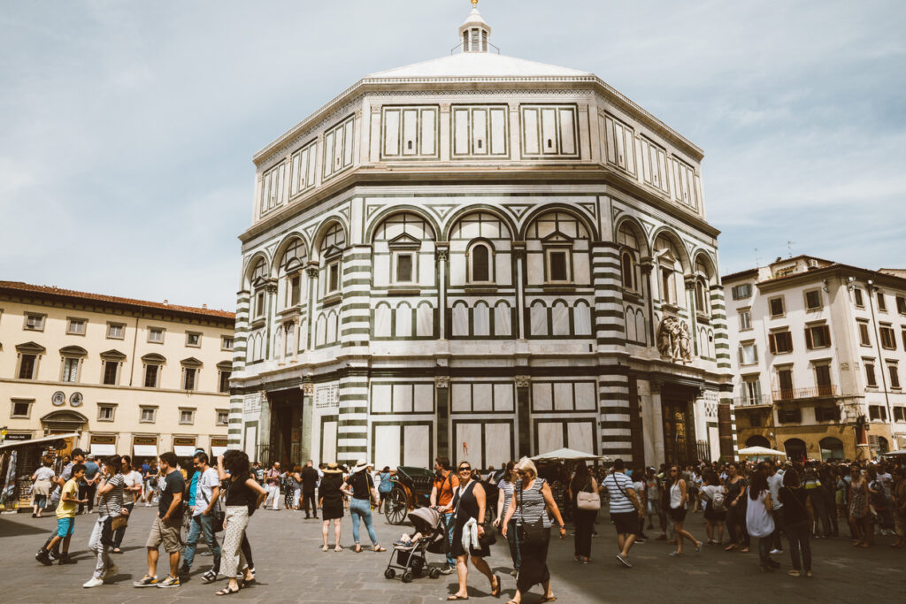 Exterior of the Baptistery of San Giovanni with its white and green marble design.