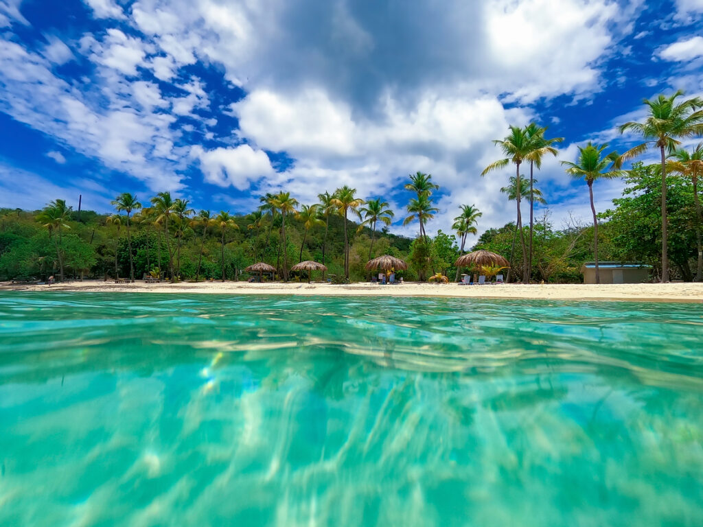 Calm turquoise water and soft sand at Honeymoon Beach on Water Island in the US Virgin Islands.