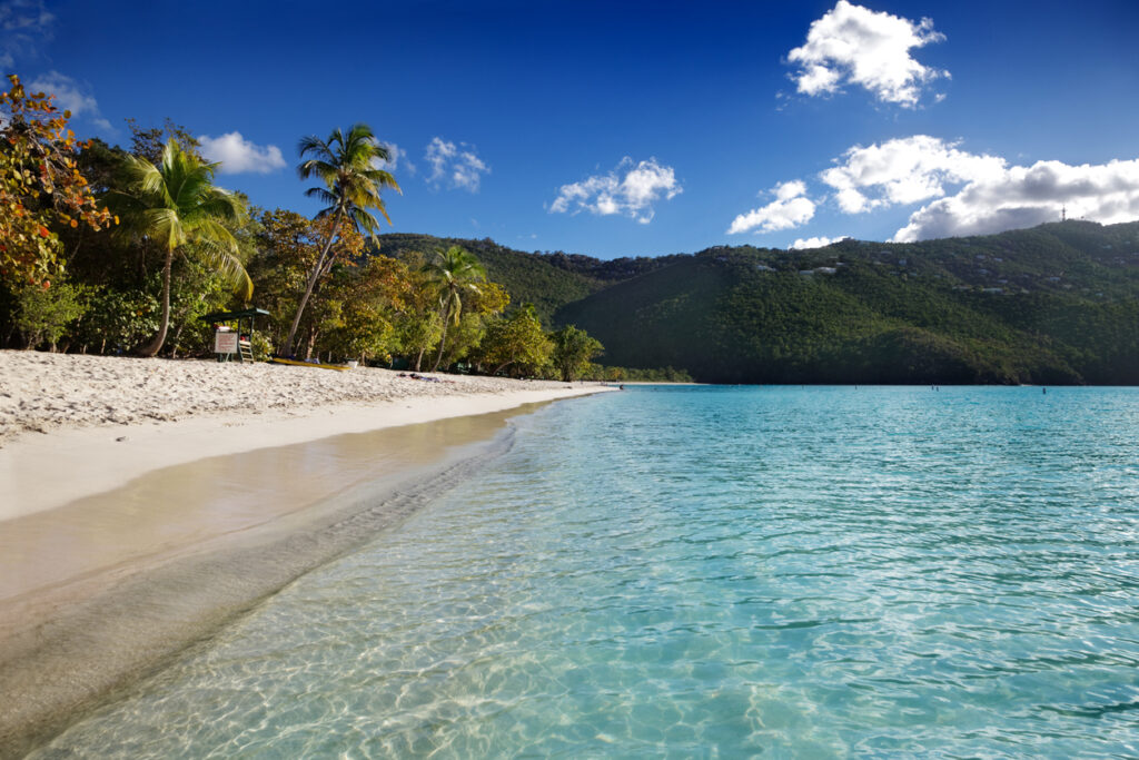 Scenic view of Magens Bay Beach in St. Thomas with calm turquoise water and surrounding green hills
