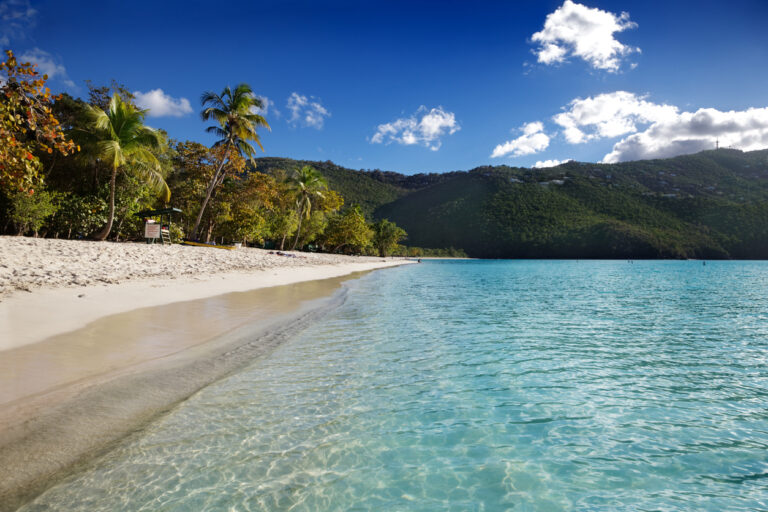 Scenic view of Magens Bay Beach in St. Thomas with calm turquoise water and surrounding green hills