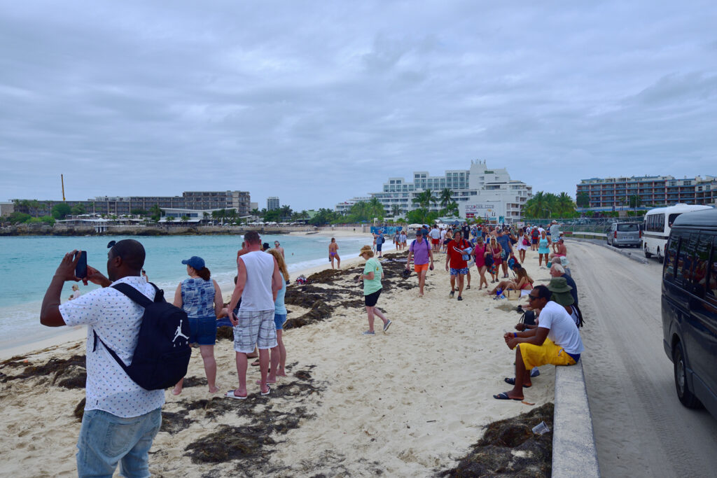 Plane spotters gathering on Maho Beach for an incoming flight at Princess Juliana International Airport.