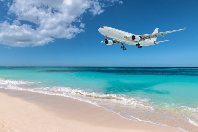 Visitors watching low‑flying planes land over Maho Beach next to Princess Juliana International Airport in St. Maarten