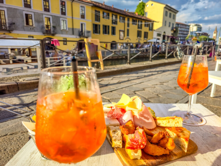 Cocktails and food by the Tessin river in the Naviglio Grande district, Milan, Italy