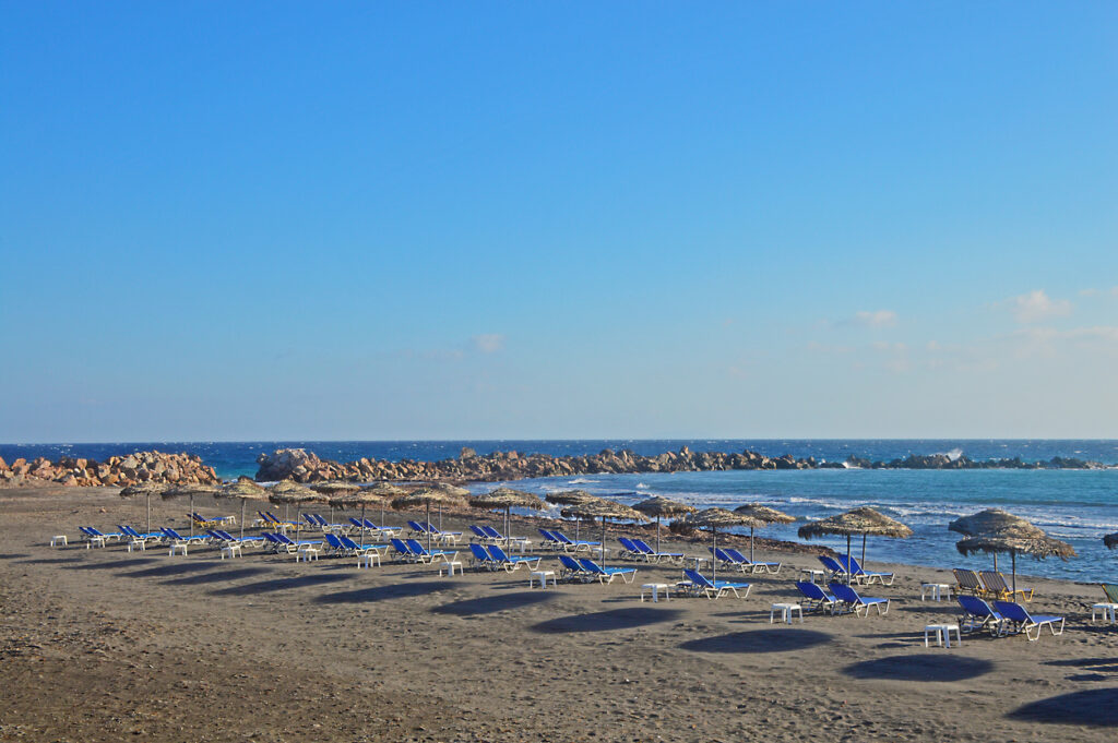 Top view over black sand beach Monolithos in Santorini, Greece.
