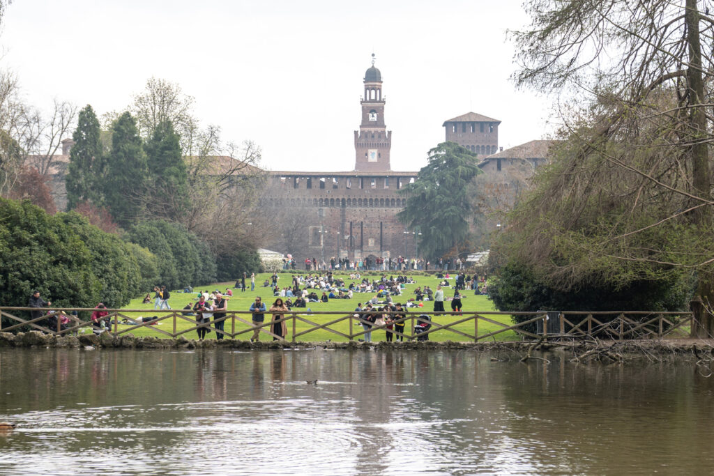 Sforza Castle with people on Parco Sempione lawn