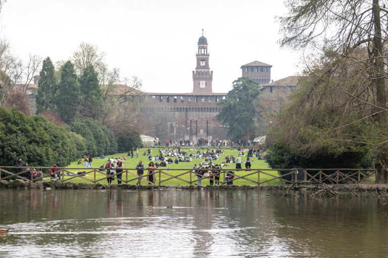 Sforza Castle with people on Parco Sempione lawn