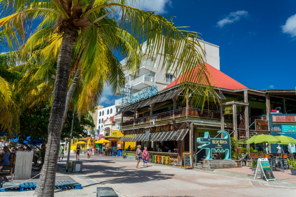 The Philipsburg Boardwalk in St. Maarten with shops, restaurants, and views of Great Bay Beach
