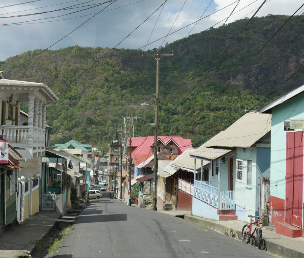 Narrow street in Soufrière, St. Lucia lined with colorful old houses and local architecture.