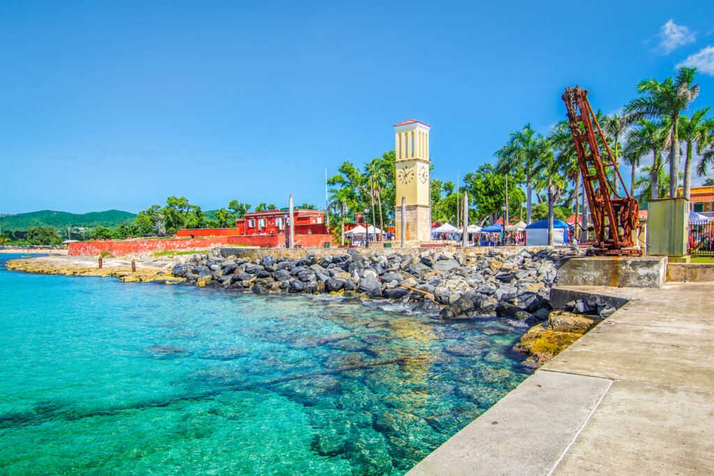 View of the Frederiksted cruise port in St. Croix featuring Fort Frederik and the historic clock tower along the waterfront.