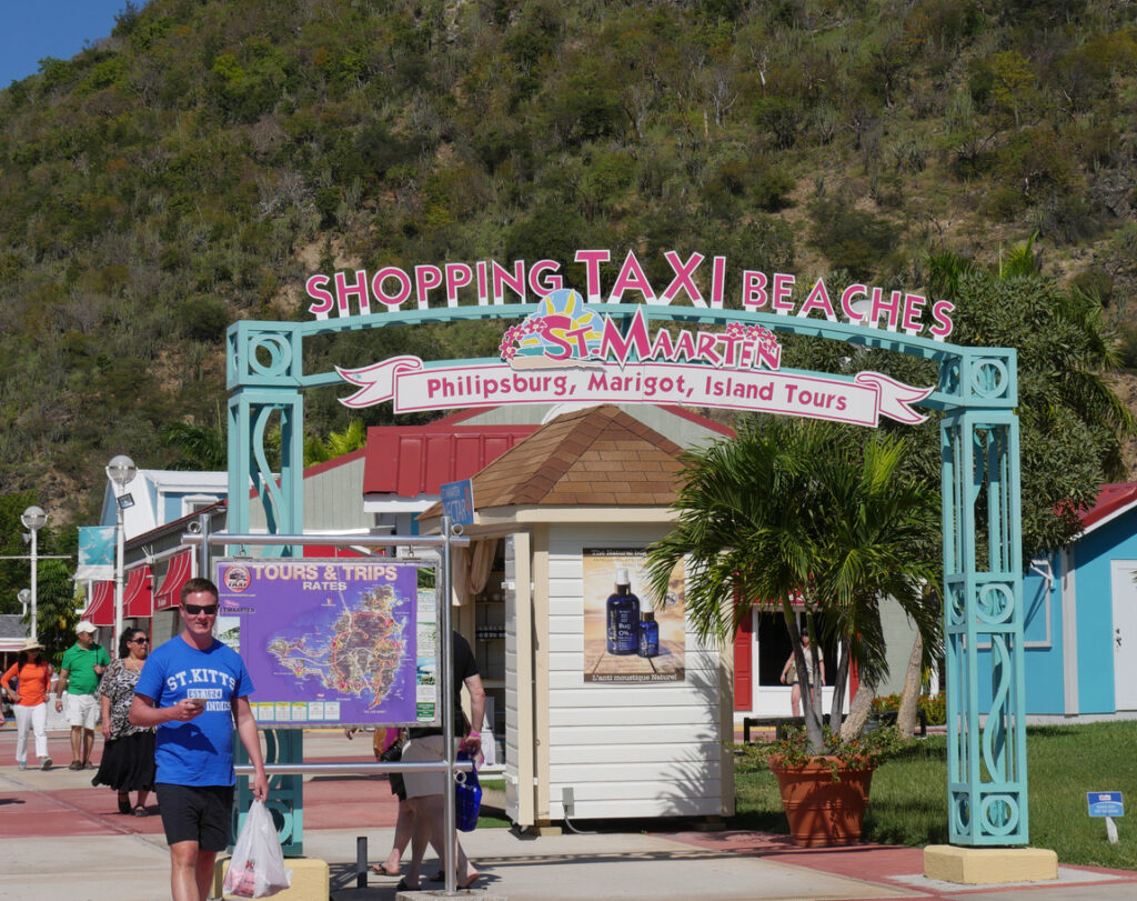 Taxi and minibus tours lined up near the St. Maarten cruise port, ready to take visitors on an island sightseeing route.