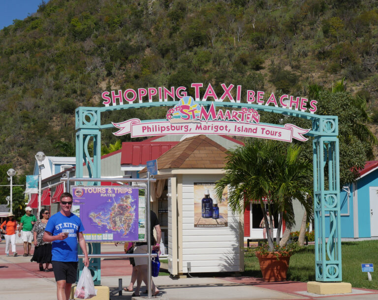 Taxi and minibus tours lined up near the St. Maarten cruise port, ready to take visitors on an island sightseeing route.