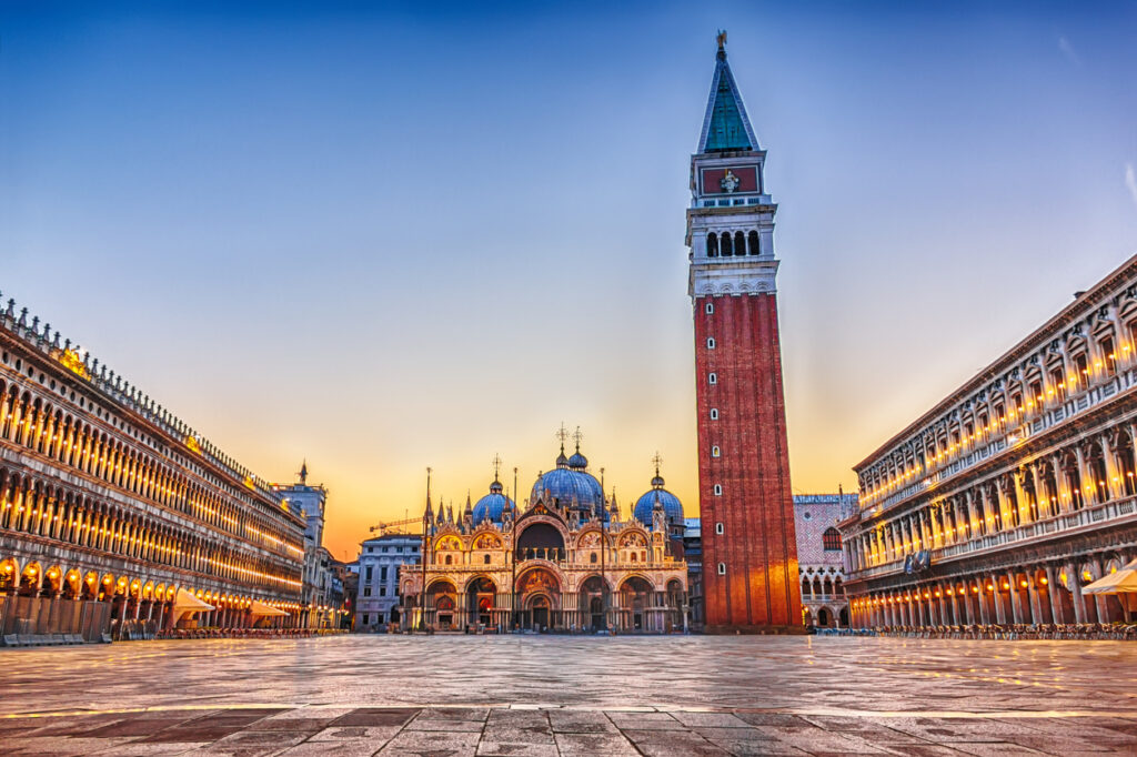 Wide view of St. Mark’s Square in Venice with St. Mark’s Basilica in the background.