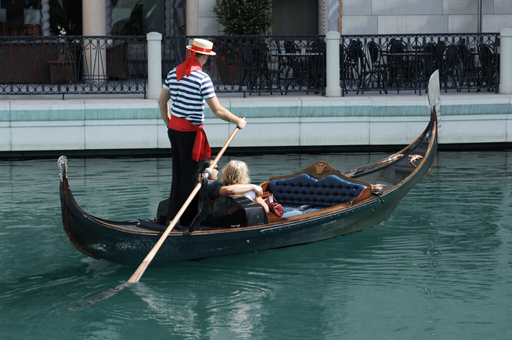 Traditional gondola gliding through a quiet canal in Venice.