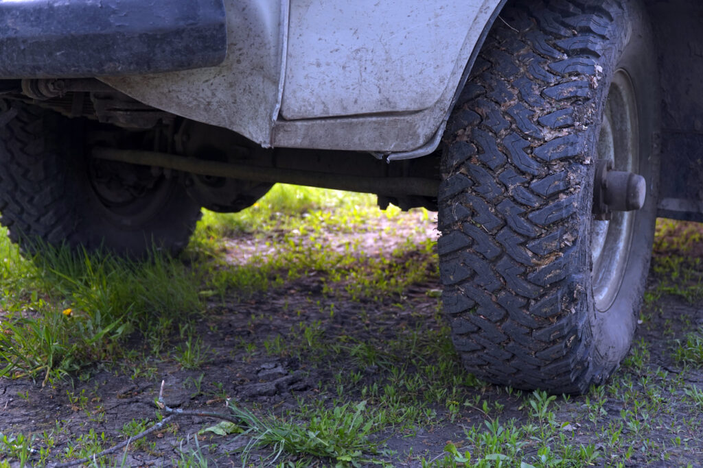 Close‑up of rugged off‑road tires designed for dirt and gravel trails, representing the wilderness ATV and Jeep tours available at Icy Strait Point in Alaska.