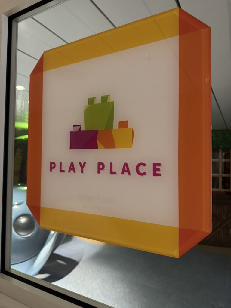 Colorful Play Place sign outside the Adventure Ocean playroom on Royal Caribbean